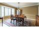 Elegant dining room featuring hardwood floors, bay window and a stylish area rug at 14261 W Evans Cir, Lakewood, CO 80228