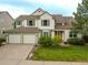 Charming two-story home with a well-manicured lawn, mature landscaping, and a spacious three-car garage at 14261 W Evans Cir, Lakewood, CO 80228