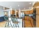 Kitchen with granite countertops, breakfast bar, stainless steel appliances, and hardwood floors at 14261 W Evans Cir, Lakewood, CO 80228