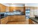 Kitchen with stainless steel appliances, hardwood floors, and a gas cooktop at 14261 W Evans Cir, Lakewood, CO 80228