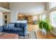 Open-concept living room with hardwood floors next to the dining area and kitchen at 14261 W Evans Cir, Lakewood, CO 80228