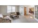 Inviting living room with plush carpeting, neutral tones, and a doorway leading to the dining area at 14261 W Evans Cir, Lakewood, CO 80228