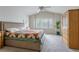 Bright main bedroom with vaulted ceiling, large window, and view of neighborhood at 14261 W Evans Cir, Lakewood, CO 80228
