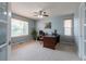 Comfortable home office with a ceiling fan, large desk, and ample natural light at 14261 W Evans Cir, Lakewood, CO 80228
