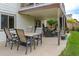 Covered patio with outdoor dining set and additional seating offers a relaxing space for entertaining at 14261 W Evans Cir, Lakewood, CO 80228