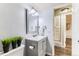 Well-lit bathroom with vanity, mirror, and modern fixtures at 10211 Ura Ln # 1-308, Thornton, CO 80260