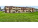 Expansive view of the building, surrounding grounds, and green space at 10211 Ura Ln # 1-308, Thornton, CO 80260