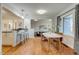 Bright dining space flowing into the living room with hardwood floors and modern decor at 2281 Florence St, Aurora, CO 80010