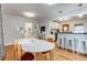 Elegant dining space with a clear view of the modern, renovated kitchen and breakfast bar at 2281 Florence St, Aurora, CO 80010