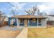 Charming single-story home with a covered porch, blue siding, and a well-maintained front yard at 2281 Florence St, Aurora, CO 80010