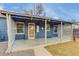 Attractive home with a covered front porch, blue siding, and well-manicured landscaping at 2281 Florence St, Aurora, CO 80010