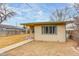 View of the exterior of the home from the backyard showing siding, a green roof trim, and a sidewalk at 2281 Florence St, Aurora, CO 80010