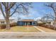 Charming blue single-story home with a well-maintained lawn and mature trees at 2281 Florence St, Aurora, CO 80010