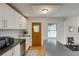 Recently renovated kitchen with white cabinets and countertops, and modern stainless steel appliances at 2281 Florence St, Aurora, CO 80010