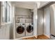 Laundry closet with side-by-side washer and dryer and slatted folding doors at 2281 Florence St, Aurora, CO 80010