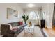 Charming living room with plush sofa, decorative art, and plenty of natural light at 2281 Florence St, Aurora, CO 80010