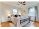 Comfortable main bedroom with a ceiling fan and large windows with stylish curtains at 2281 Florence St, Aurora, CO 80010