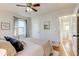 Bright main bedroom with en-suite bathroom access, closet doors, and large window at 2281 Florence St, Aurora, CO 80010