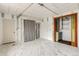 An empty room with painted floorboards, bright lighting, and multiple doors at 2281 Florence St, Aurora, CO 80010