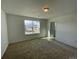 Cozy bedroom featuring carpeted floors and a large window overlooking the neighborhood at 545 Twilight St, Erie, CO 80516