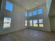 Bright living room with high ceilings, large windows, and sleek hardwood floors at 545 Twilight St, Erie, CO 80516