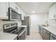 Galley kitchen features stainless steel appliances and ample counter space at 10303 E Peakview Ave # G203, Englewood, CO 80111
