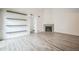 Cozy living room featuring floating shelves and a charming fireplace at 10303 E Peakview Ave # G203, Englewood, CO 80111