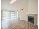Spacious living room features skylight, floating shelves, and a cozy fireplace at 10303 E Peakview Ave # G203, Englewood, CO 80111