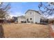 Spacious backyard with a wooden play structure, a trampoline, a cozy patio area, and a well-maintained lawn at 1212 Magpie Ave, Brighton, CO 80601