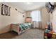 Cozy bedroom featuring a twin bed with storage and dinosaur-themed decor at 1212 Magpie Ave, Brighton, CO 80601