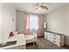 Bright bedroom with a ceiling fan, twin bed, vanity, and neutral walls at 1212 Magpie Ave, Brighton, CO 80601