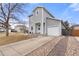 Attractive two-story home boasts a neat front yard, attached garage, and a welcoming front entrance at 1212 Magpie Ave, Brighton, CO 80601