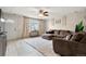 Cozy living room with a white door, tile floors, a comfortable sofa, and ample natural light at 1212 Magpie Ave, Brighton, CO 80601