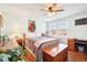 Cozy bedroom features a ceiling fan, hardwood floors, and bright natural light at 2805 Jasmine St, Denver, CO 80207