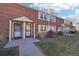 Classic red brick townhomes with traditional shutters and covered entryways along a well-maintained lawn at 2805 Jasmine St, Denver, CO 80207