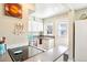 Efficient kitchen layout featuring modern appliances, white cabinetry, and a convenient breakfast bar at 2805 Jasmine St, Denver, CO 80207