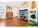 Cozy living room with hardwood floors, a staircase, and a laundry closet with modern appliances at 2805 Jasmine St, Denver, CO 80207