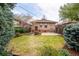 Well-kept backyard with mature trees, a patio, and a grassy area at 3361 W 36Th Ave, Denver, CO 80211