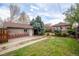 Backyard featuring a detached garage, mature trees, and a well-maintained lawn at 3361 W 36Th Ave, Denver, CO 80211