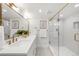Refined bathroom with dual sinks, elegant gold fixtures, and a glass-enclosed shower at 3361 W 36Th Ave, Denver, CO 80211