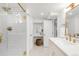 Bright bathroom featuring a glass shower with gold fixtures, a vanity, and ample lighting at 3361 W 36Th Ave, Denver, CO 80211