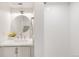 Modern bathroom featuring a round mirror, a white vanity and a tiled shower at 3361 W 36Th Ave, Denver, CO 80211