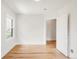 Inviting room showcasing pristine white walls and gleaming hardwood floors at 3361 W 36Th Ave, Denver, CO 80211
