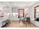 Bright dining area features a built-in bench, modern light fixture, and seamless flow to the kitchen at 3361 W 36Th Ave, Denver, CO 80211