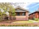 Charming brick home with a cozy front porch and manicured landscaping at 3361 W 36Th Ave, Denver, CO 80211