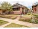 Well-maintained home boasts a brick facade, landscaped front yard, and inviting curb appeal at 3361 W 36Th Ave, Denver, CO 80211