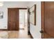Hallway with hardwood floors and original trim leading to a full bathroom with natural light at 3361 W 36Th Ave, Denver, CO 80211