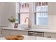 Bright kitchen with a white countertop, modern gold faucet, and view of the exterior at 3361 W 36Th Ave, Denver, CO 80211