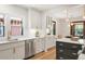 Bright kitchen with white cabinets, stainless steel appliances and fixtures, and a modern island at 3361 W 36Th Ave, Denver, CO 80211