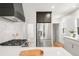 Bright kitchen featuring stainless steel appliances, white countertops, and a modern gas range at 3361 W 36Th Ave, Denver, CO 80211